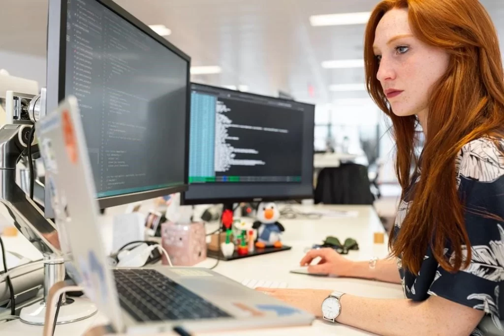 A woman in an office researching digital customer service during a meeting